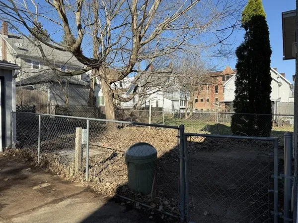 a two chairs sitting in backyard of the house
