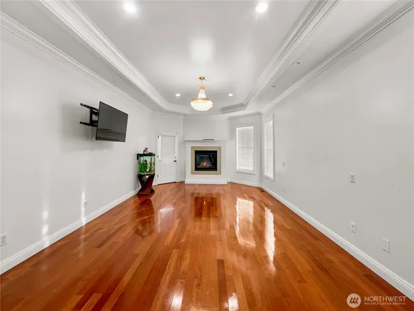 wooden floor in an empty room with a fireplace