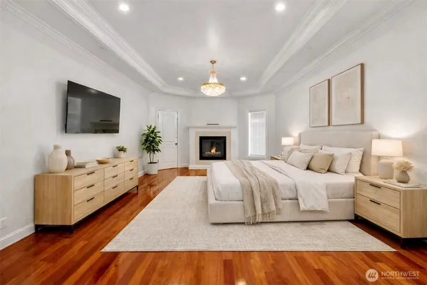 a spacious bedroom with a bed and a flat screen television