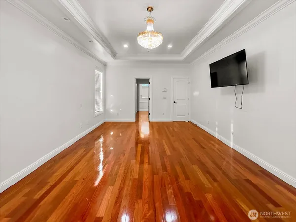a big room with wooden floor and windows