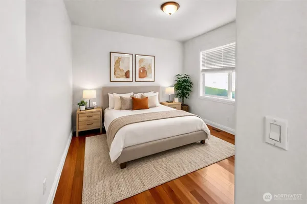 a bedroom with a bed and a night stand