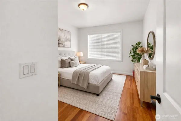 a bed sitting in a bedroom next to a window