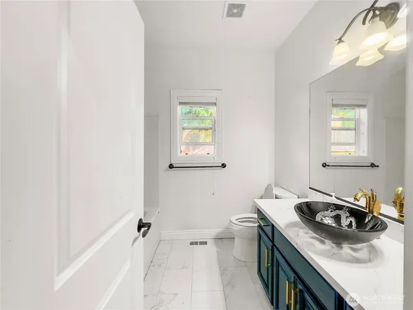 a bathroom with a sink stove and shower