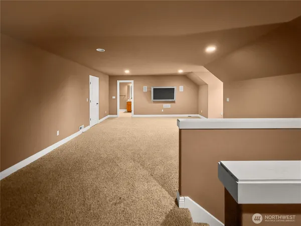 a spacious bedroom with a bed a mirror and lamp