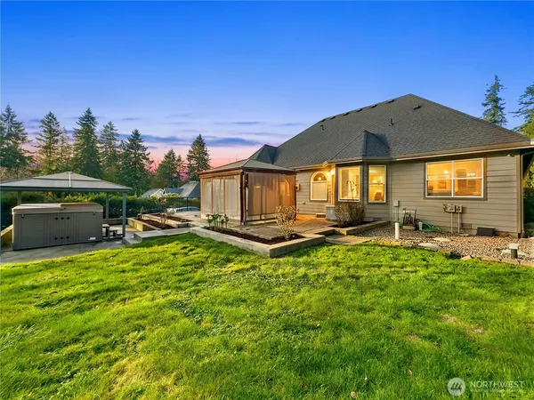 a view of a house with backyard and sitting area