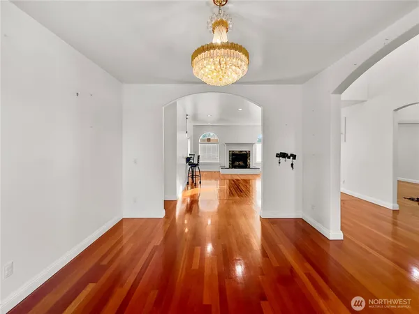 a view of a room with wooden floor