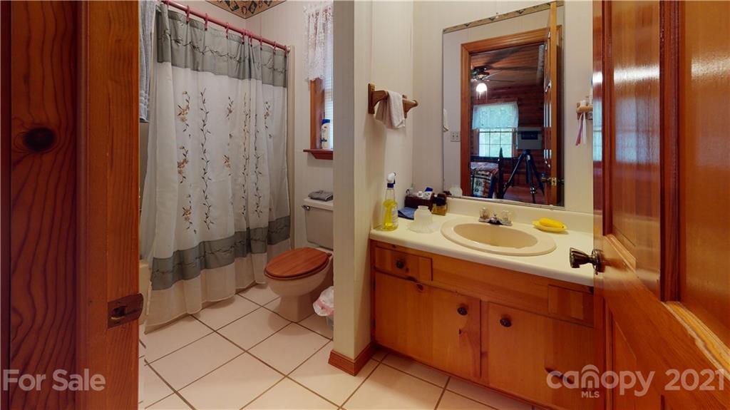 373 North Burris Road Sharon, SC 29742 - Photo 29 of 36 a bathroom with a sink a toilet a mirror and shower