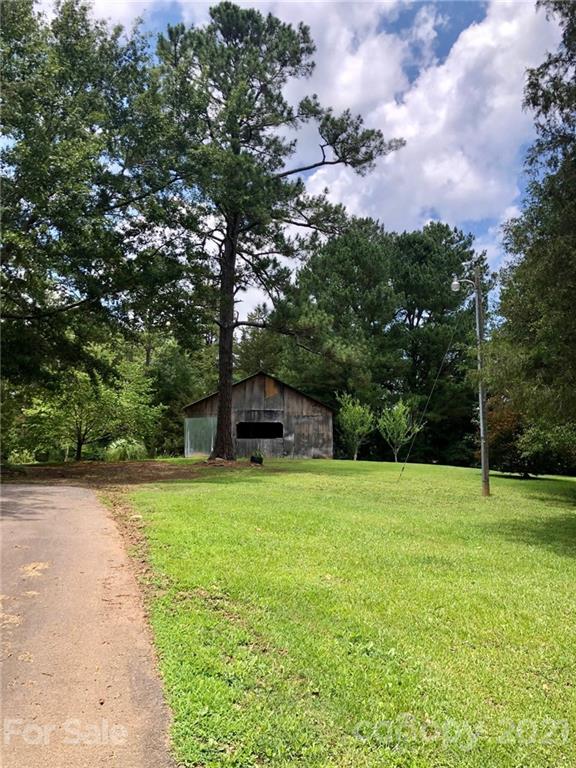 373 North Burris Road Sharon, SC 29742 - Photo 8 of 36 a tall tree in middle of green field
