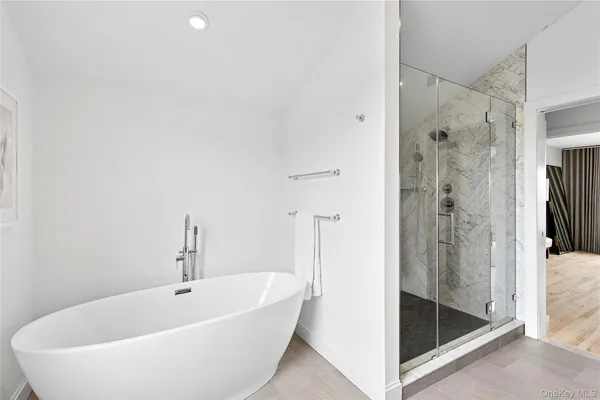 a bathroom with a bathtub and shower