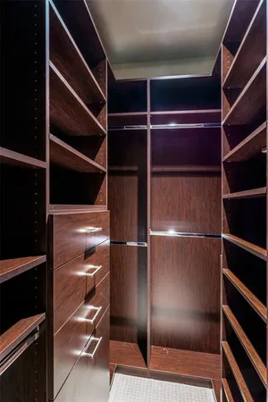 a view of walk in closet with empty racks