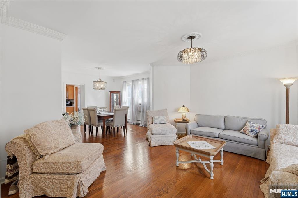 385 Berkeley Avenue Bloomfield, NJ 07003 - Photo 8 of 39 a living room with furniture a dining table and a chandelier