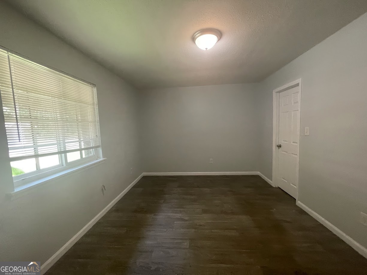 140 Se Mount, Unit 36 Atlanta, GA 30354 - Photo 4 of 13 an empty room with wooden floor and windows
