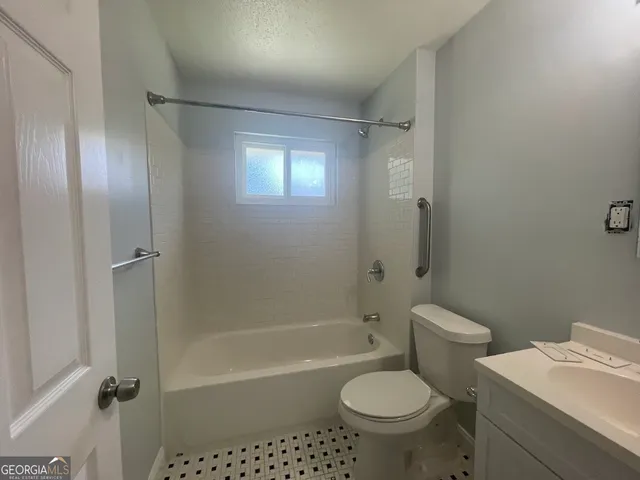 a bathroom with a toilet sink and shower