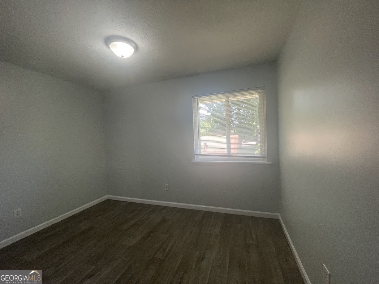 140 Se Mount, Unit 36 Atlanta, GA 30354 - Photo 6 of 13 an empty room with wooden floor and windows