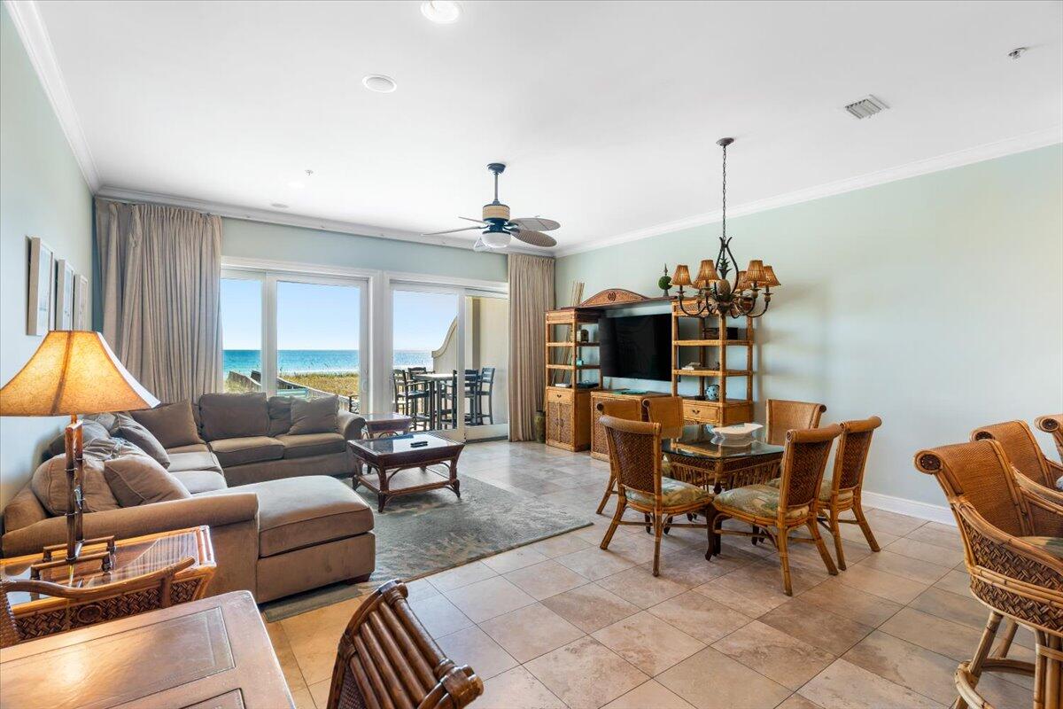7923 Gulf Boulevard Navarre, FL 32566 - Photo 12 of 33 a living room with furniture a chandelier and a dining table