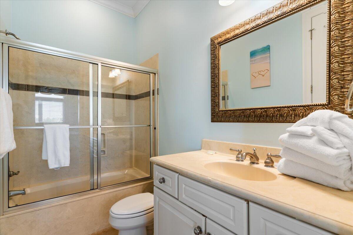 7923 Gulf Boulevard Navarre, FL 32566 - Photo 22 of 33 a bathroom with a granite countertop sink toilet and shower