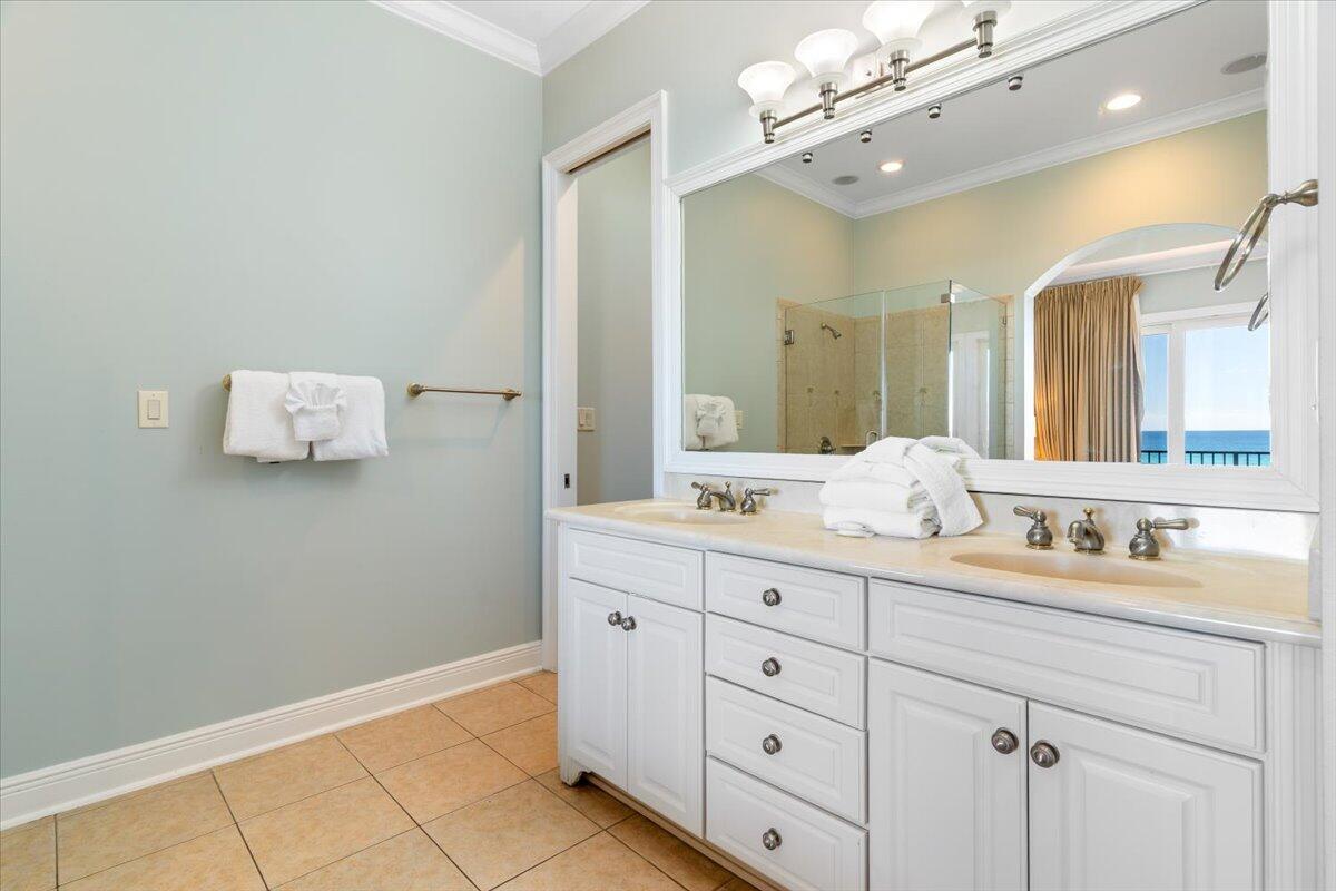 7923 Gulf Boulevard Navarre, FL 32566 - Photo 23 of 33 a bathroom with a sink vanity and mirror