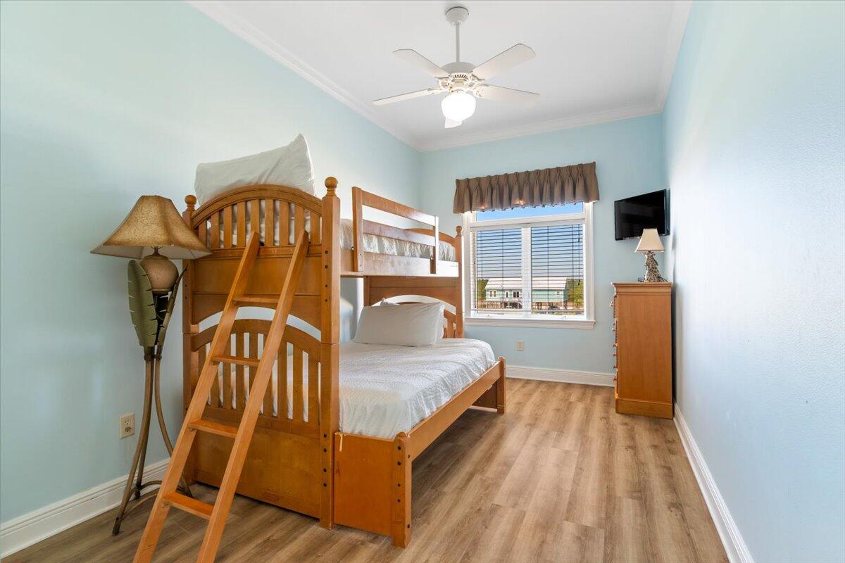 7923 Gulf Boulevard Navarre, FL 32566 - Photo 27 of 33 a bedroom with a bed and a window
