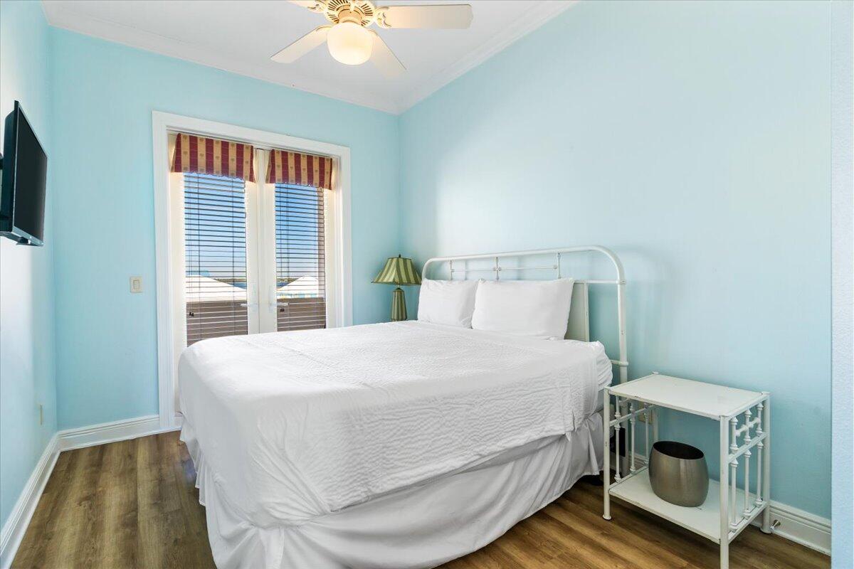 7923 Gulf Boulevard Navarre, FL 32566 - Photo 28 of 33 a bedroom with a bed and a tv