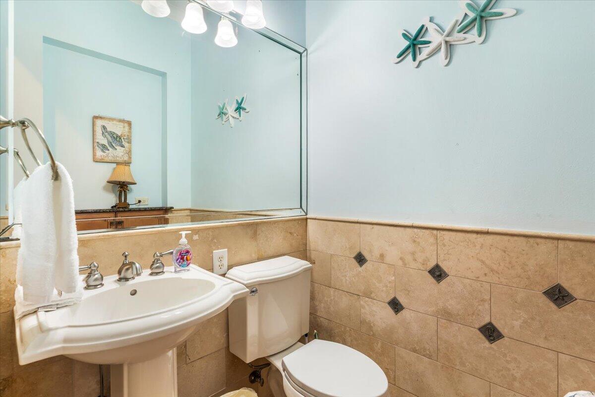 7923 Gulf Boulevard Navarre, FL 32566 - Photo 29 of 33 a bathroom with a sink a toilet and shower curtain