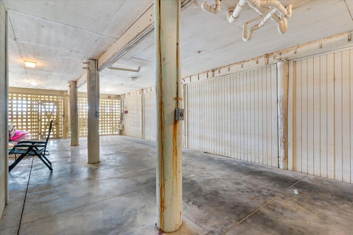 7923 Gulf Boulevard Navarre, FL 32566 - Photo 32 of 33 a view of a hallway with a chandelier