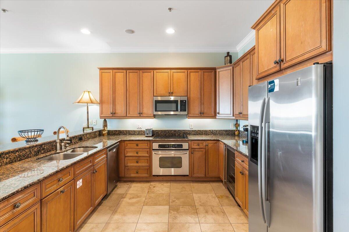 7923 Gulf Boulevard Navarre, FL 32566 - Photo 10 of 33 a kitchen with stainless steel appliances granite countertop a sink stove refrigerator and cabinets