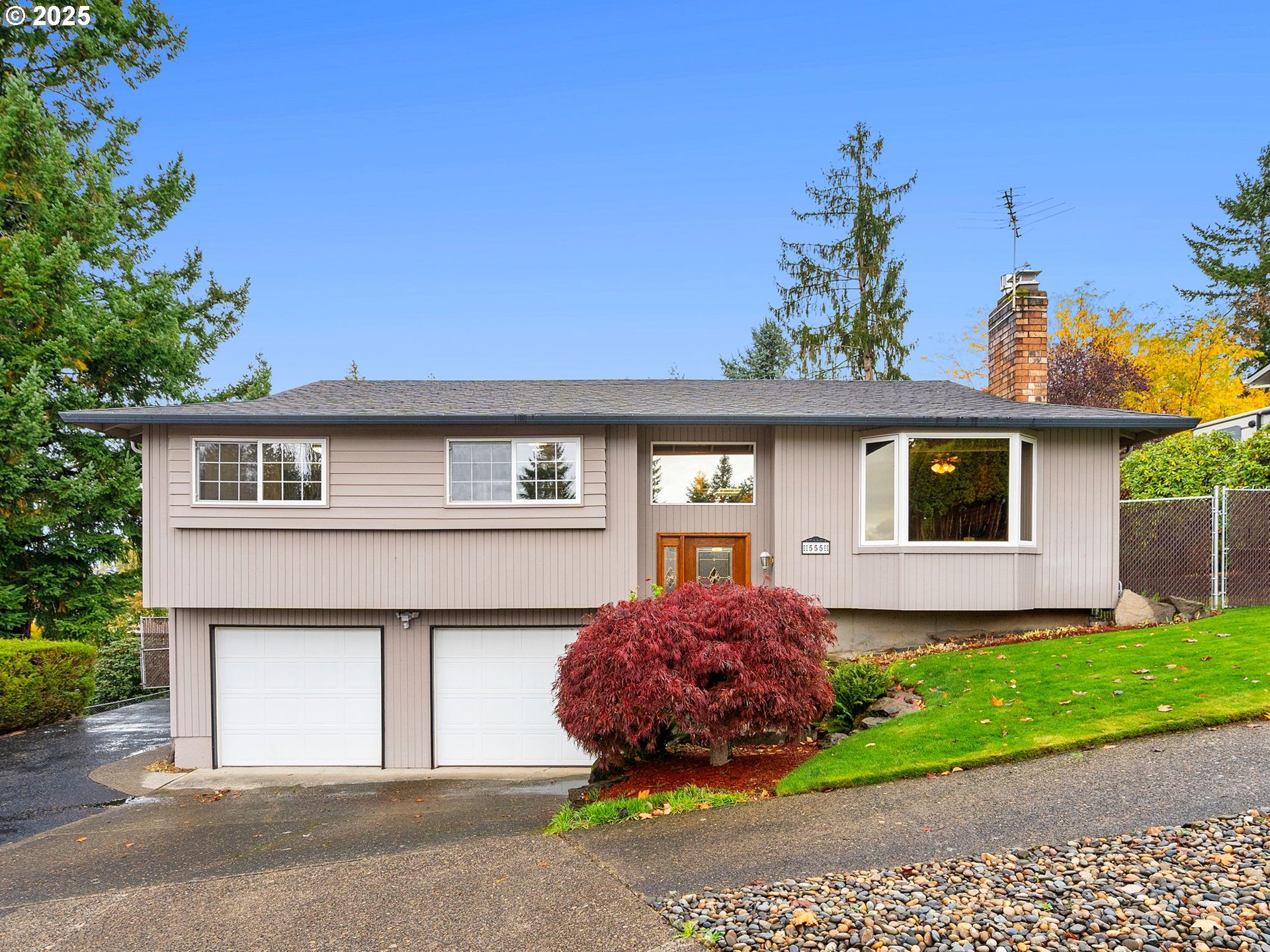 555 Southwest 7th Street Gresham, OR 97080 - Photo 2 of 48 a front view of a house with a garden and plants