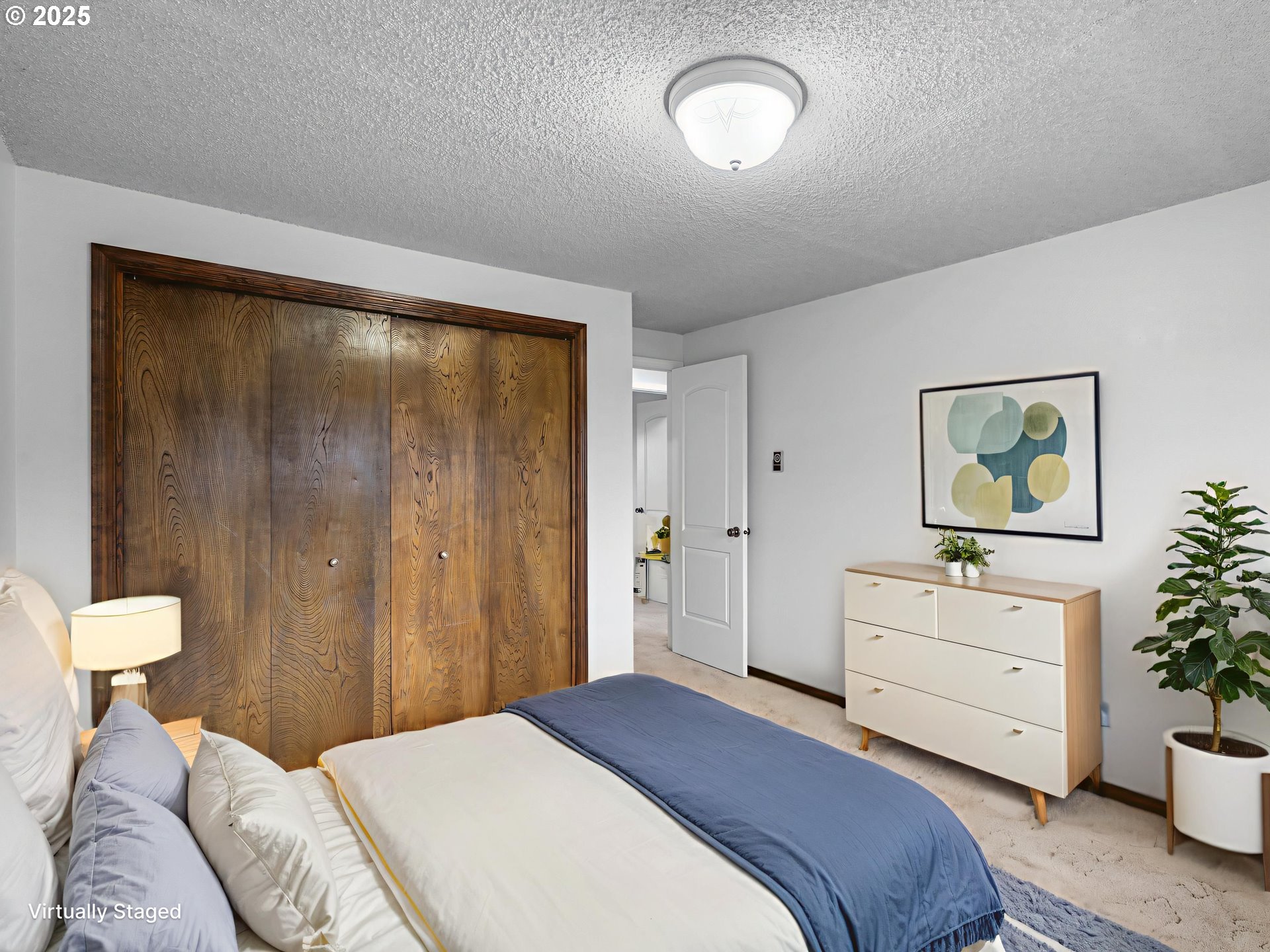 555 Southwest 7th Street Gresham, OR 97080 - Photo 24 of 48 a bedroom with a bed and a potted plant