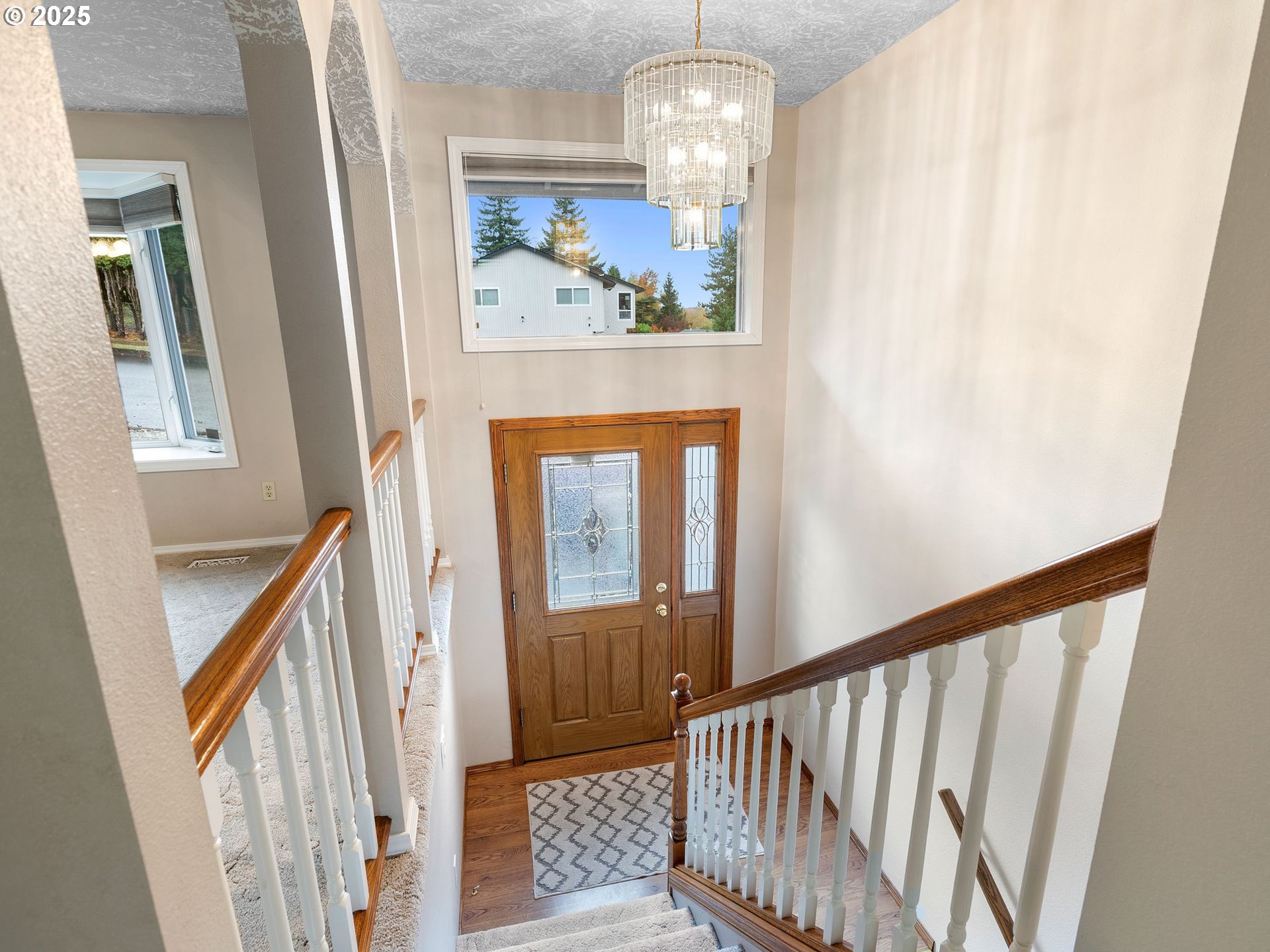 555 Southwest 7th Street Gresham, OR 97080 - Photo 29 of 48 a view of a hallway to a livingroom with wooden floor and stairs