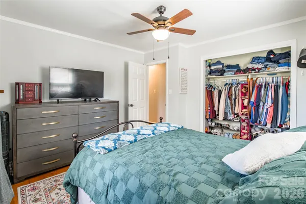 a bed room with a bed and a television