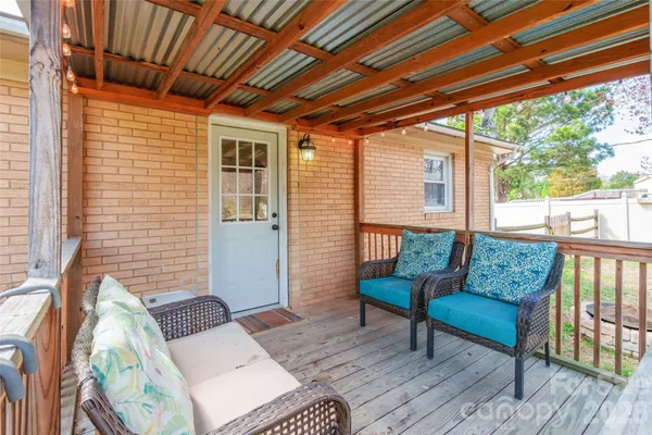 a outdoor living space with furniture and a wooden floor