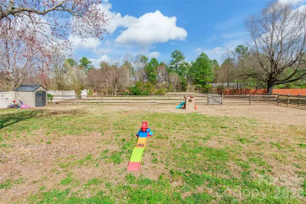 a park view with multi story residential apartment building in the back