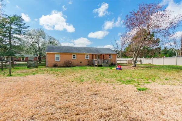 a view of a house with a backyard