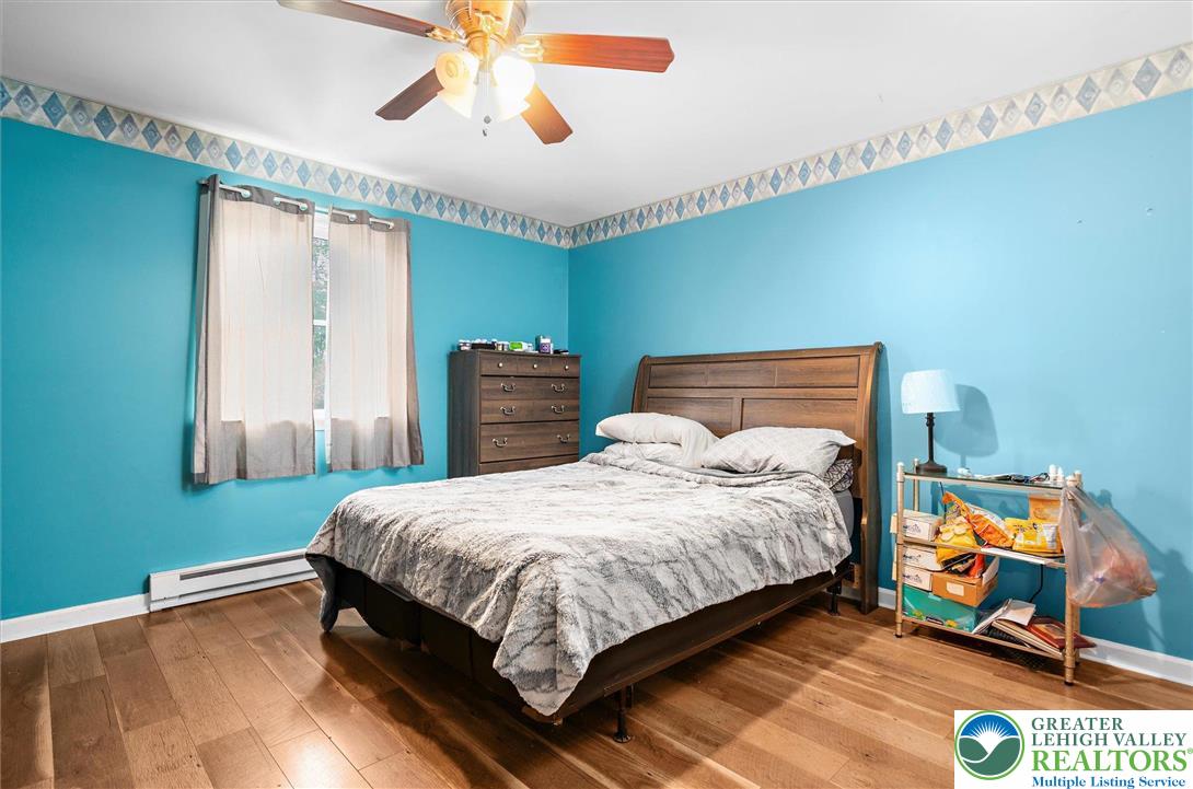 326 Chestnut Street Slatington, PA 18080 - Photo 12 of 28 a bedroom with a bed and wooden floor