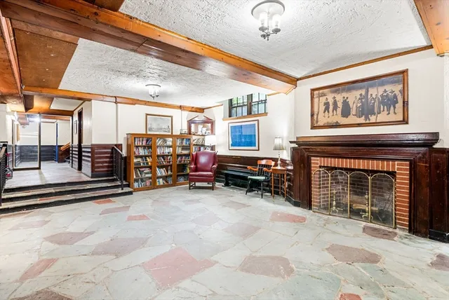 a view of a livingroom with fireplace and a window