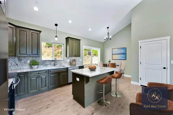 a kitchen with kitchen island granite countertop a sink counter top space and appliances