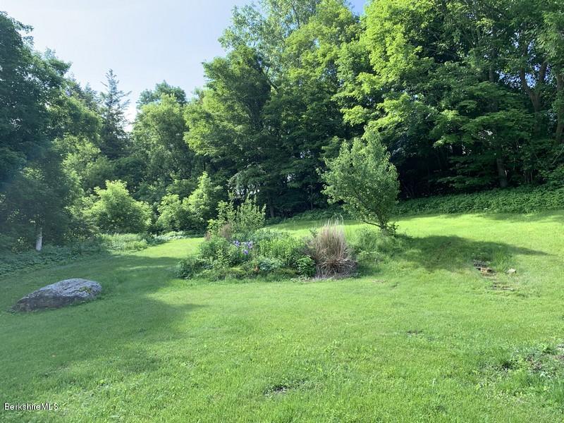 223 East Road Adams, MA 01220 - Photo 9 of 22 a view of a grassy field with trees in the background