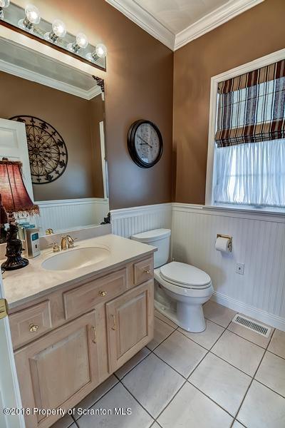 360 Upper Demunds Road Dallas, PA 18612 - Photo 18 of 40 a bathroom with a toilet a sink and a shower curtain