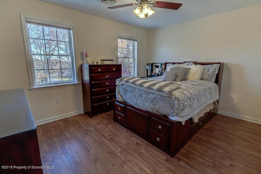 360 Upper Demunds Road Dallas, PA 18612 - Photo 23 of 40 a spacious bedroom with a bed and dresser with wooden floor