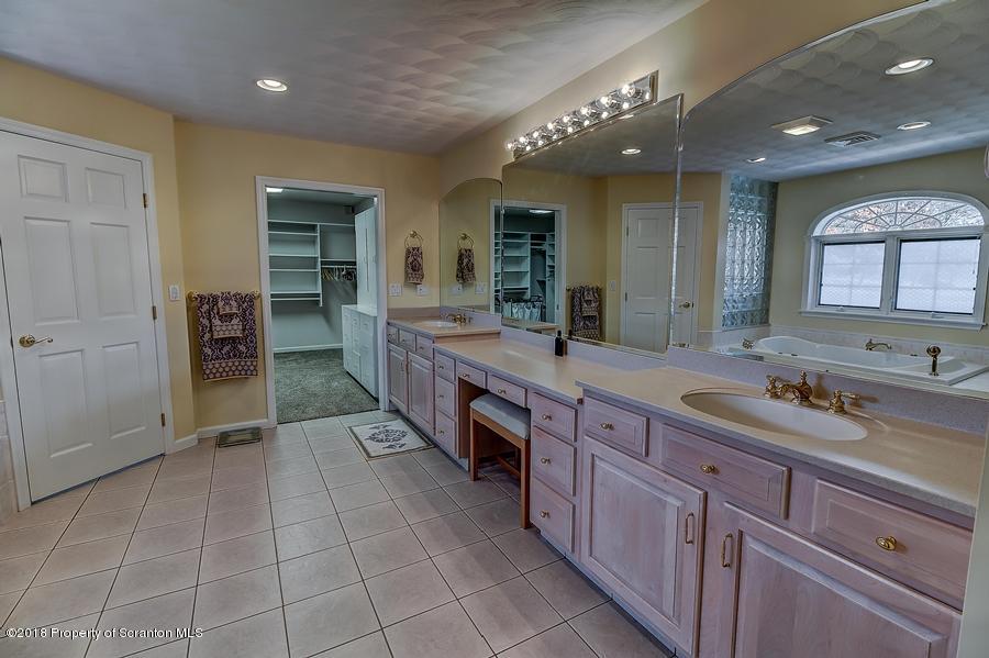 360 Upper Demunds Road Dallas, PA 18612 - Photo 29 of 40 a spacious bathroom with a granite countertop sink mirror and shower