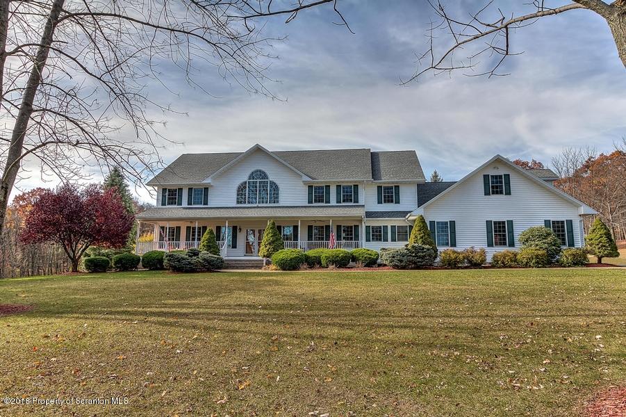 360 Upper Demunds Road Dallas, PA 18612 - Photo 40 of 40 a front view of a house with a garden and trees
