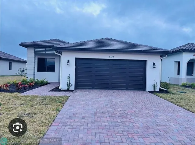 a front view of a house with a yard and garage