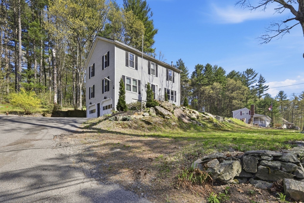 66 Buttonwood Avenue Sutton, MA 01590 - Photo 11 of 42 a view of a house with a yard