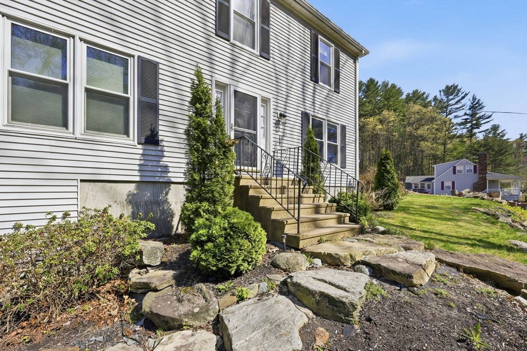 66 Buttonwood Avenue Sutton, MA 01590 - Photo 12 of 42 a view of a house with a yard and a garden