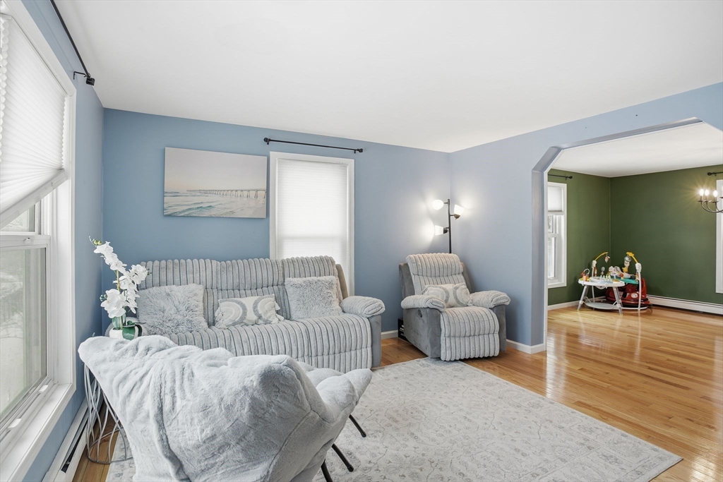 66 Buttonwood Avenue Sutton, MA 01590 - Photo 20 of 42 a living room with furniture and a large mirror next to a window