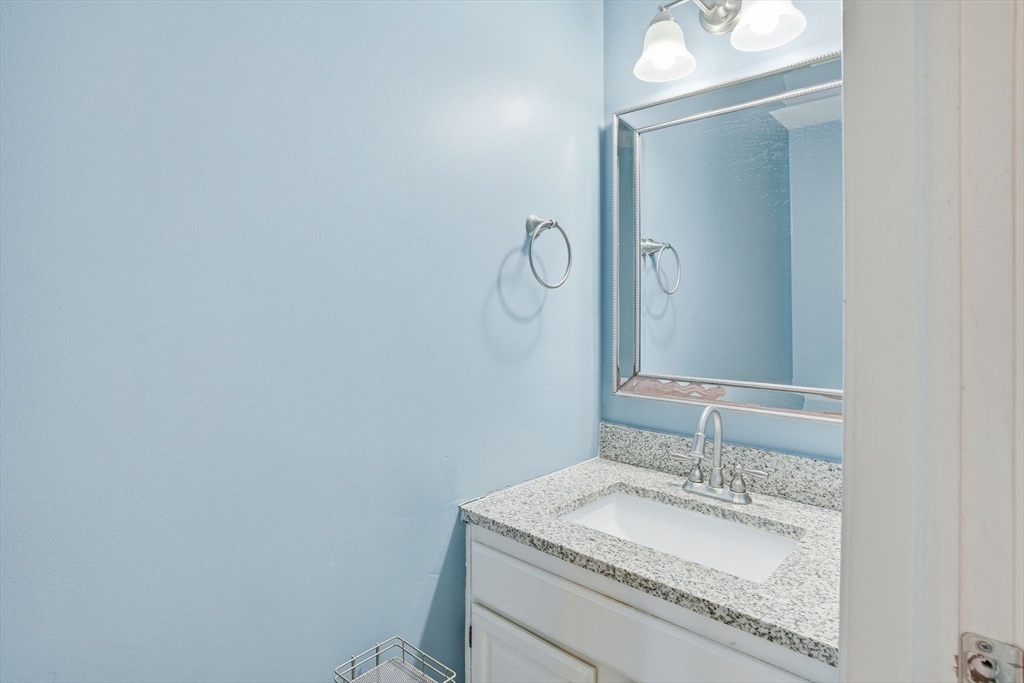 66 Buttonwood Avenue Sutton, MA 01590 - Photo 22 of 42 a bathroom with a granite countertop sink and a mirror