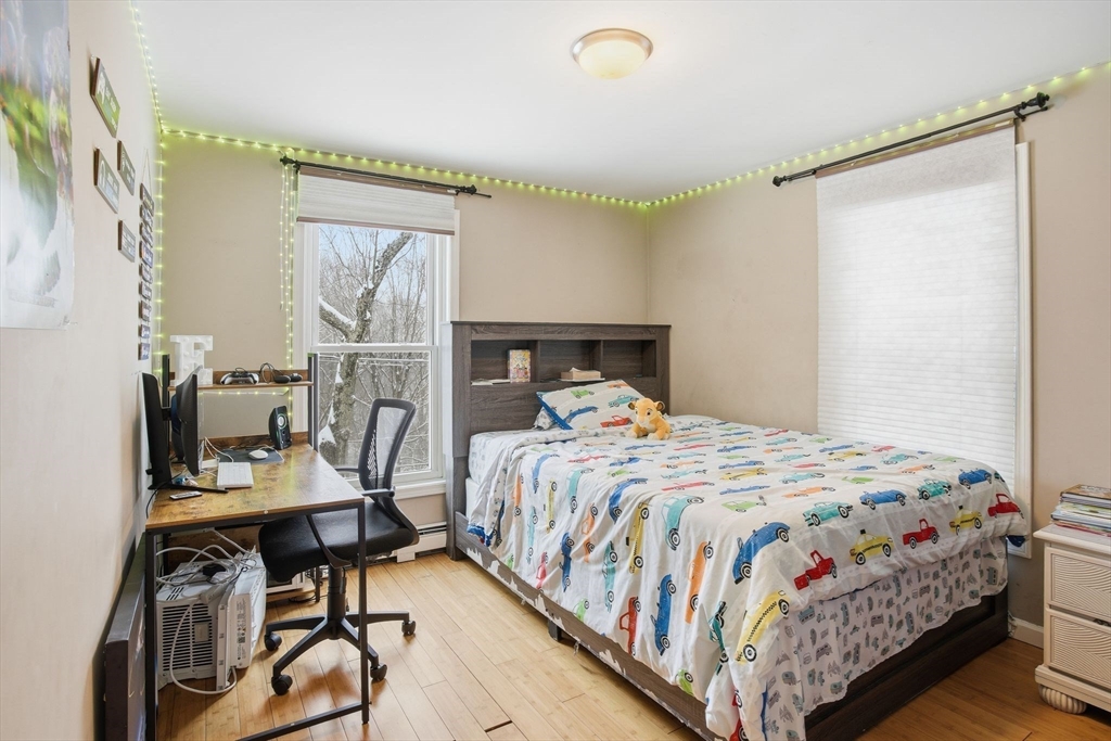 66 Buttonwood Avenue Sutton, MA 01590 - Photo 25 of 42 a bedroom with a bed a table and chair