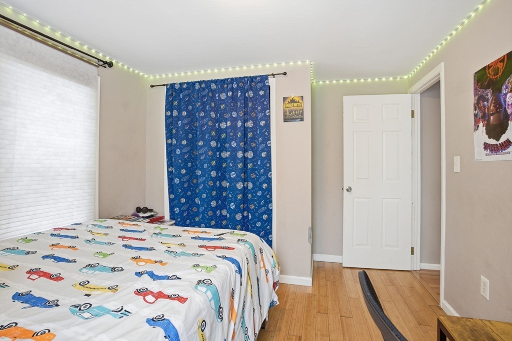 66 Buttonwood Avenue Sutton, MA 01590 - Photo 26 of 42 a bedroom with a bed and a painting on the wall