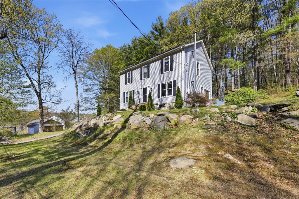 66 Buttonwood Avenue Sutton, MA 01590 - Photo 10 of 42 a view of a house with a yard