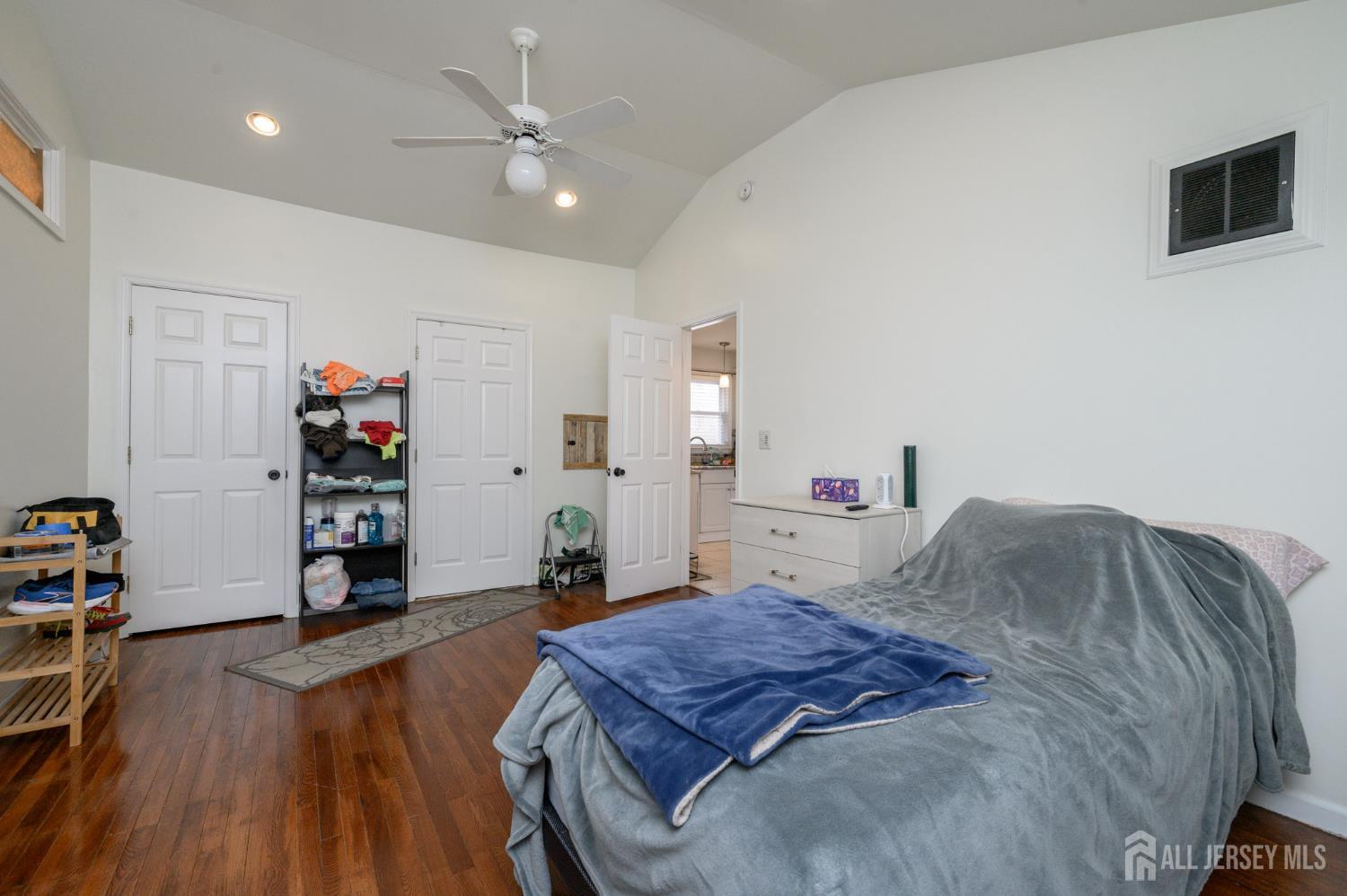 384 Cook Road Jackson, NJ 08527 - Photo 11 of 31 a bedroom with a bed and a bookshelf with wooden floor